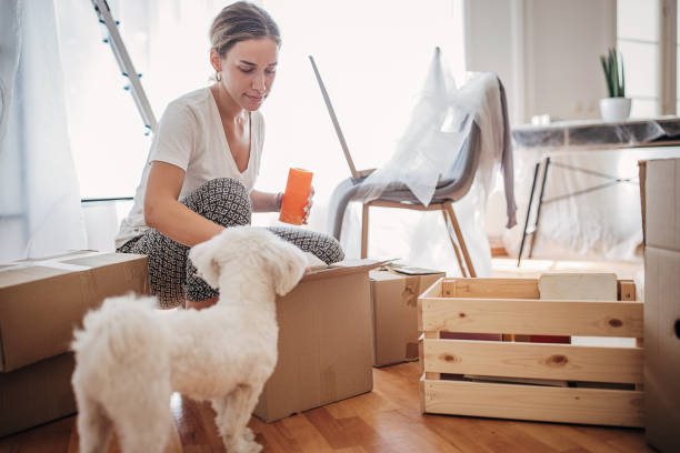 istock Woman unpacking in new apartment 1424343992
