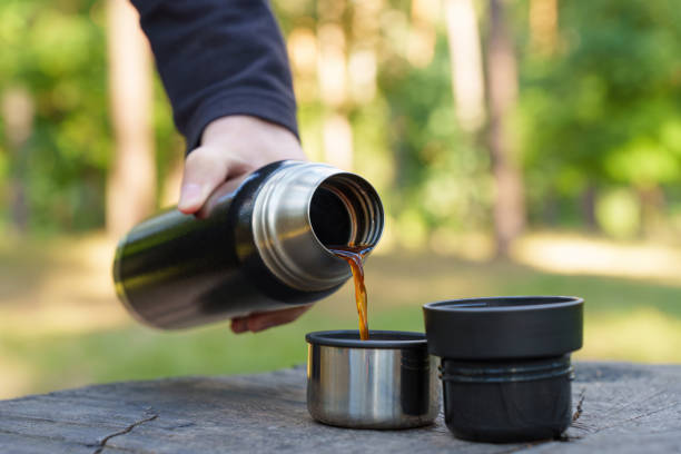 istock Coffee break on a tree stump in the forest 1424344223