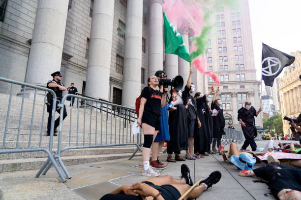 XRNYC  Smoke Extinction Rebellion NYC stages a protest against SCOTUS amending the "Clean Air Act" shown here lying down in protest. extinction rebellion photos stock pictures, royalty-free photos & images