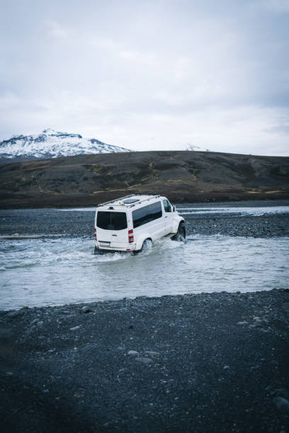 istock 4x4 vehicle crosses river on moody day 1424350899