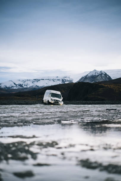 istock 4x4 vehicle crosses river on moody day 1424351913