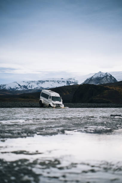 istock 4x4 vehicle crosses river on moody day 1424351955