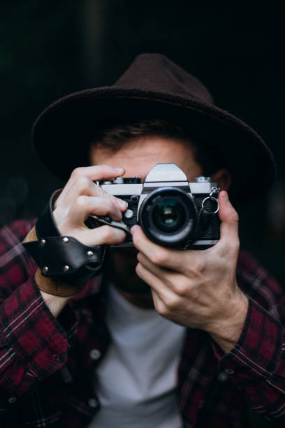 istock The man is taking a picture with a film camera 1424357688