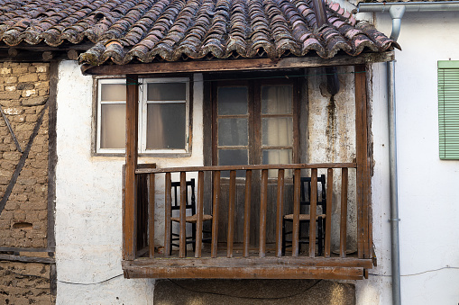 Old wooden balcony with two chairs, popular architecture concept