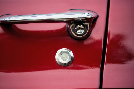 Detail of a red vintage car door