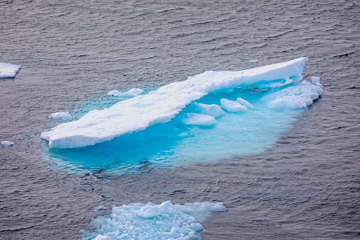 Close up of iceberg in Greenland with stunning blue aquamarine colour