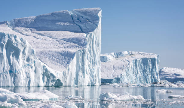 Towering great icebergs in the Ilulissat Icefjord in Greenland stock photo