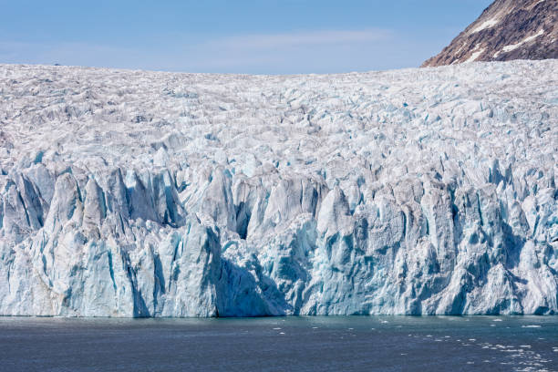 Close up of the huge face of a craggy glacier in Prince Christian Sound, South Greenland stock photo
