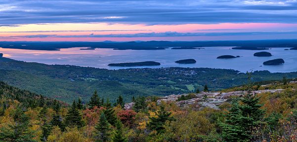A panoramic overview of Bar Harbor and its islands at Frenchman Bay on a colorful Autumn evening, as seen from Cadillac Mountain of Acadia National Park. Maine, USA.