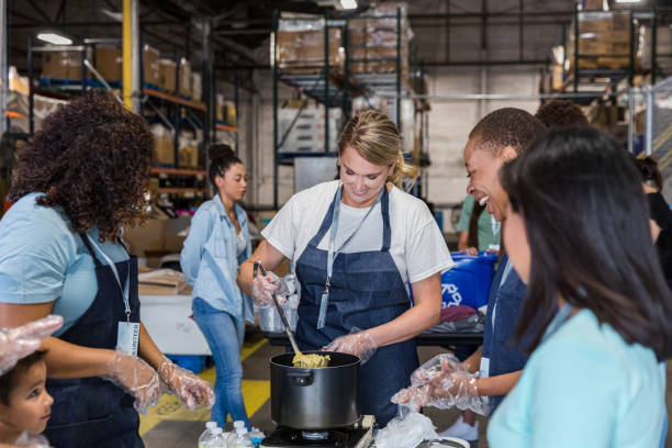 istock Diverse group of volunteers work as a team 1424369167
