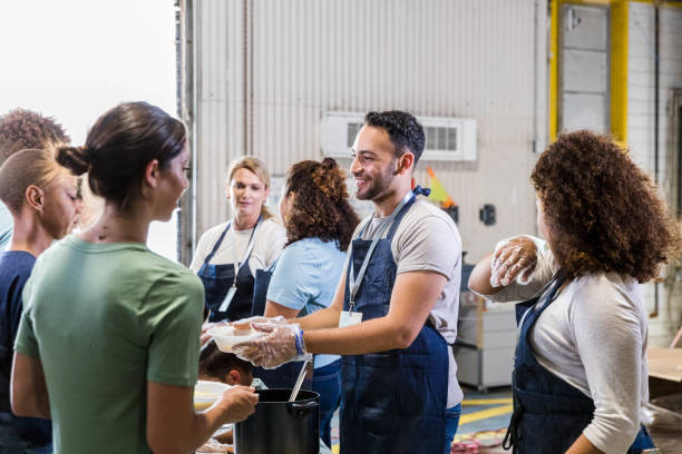 istock Diverse group of volunteers help serve meals 1424369202