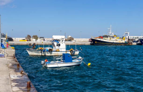 View of the port, parked ships, marina and sea on a sunny, spring day (Kimi, Euboea, Greece)