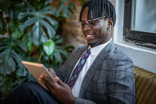 istock Portrait of a businessman working on a tablet from a restaurant 1424374002