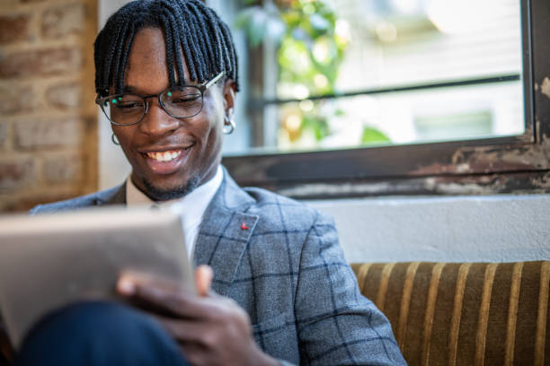 istock Portrait of a businessman working on a tablet from a restaurant 1424374007