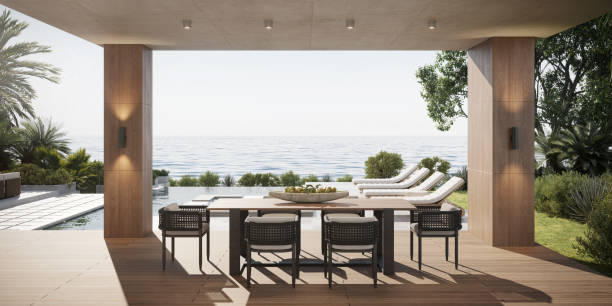 istock Computer generated image of luxury house poolside overlooking the sea 1424381501