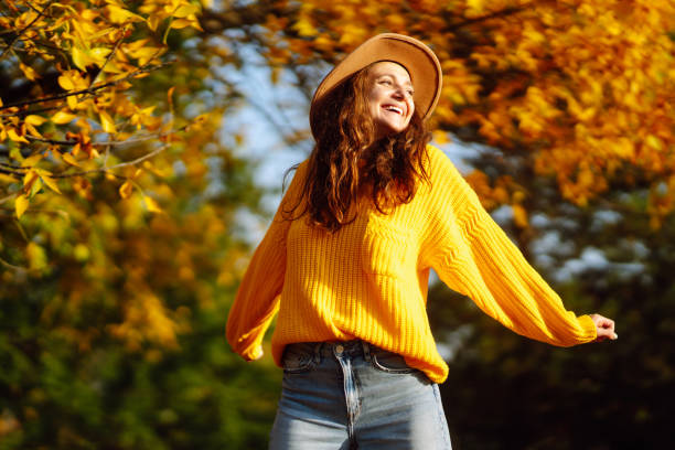istock Fall picnic with pumpkin. Young woman resting in nature. 1424386103