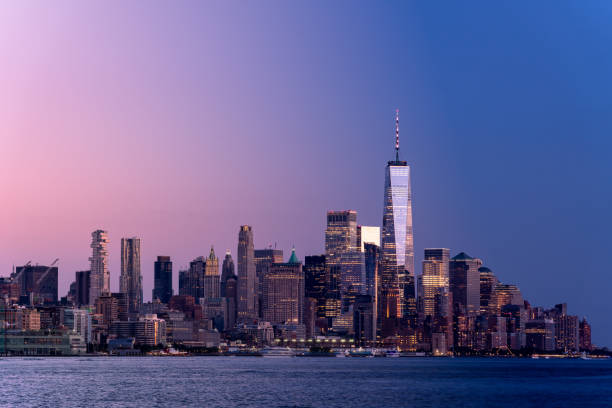 dramatic view of lower manhattan at dusk - new york stockfoto's en -beelden