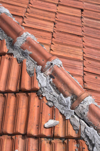 istock old tiles on the roof repaired with cement 1424394251