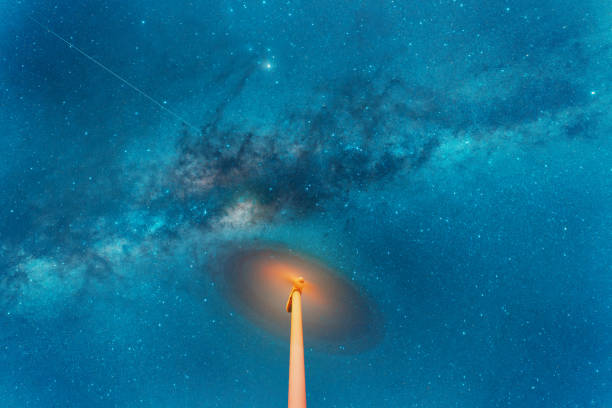 night sky over a spinning wind turbine, long exposure