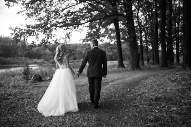 istock Young couple enjoying romantic moments while walking in the park. 1424400325