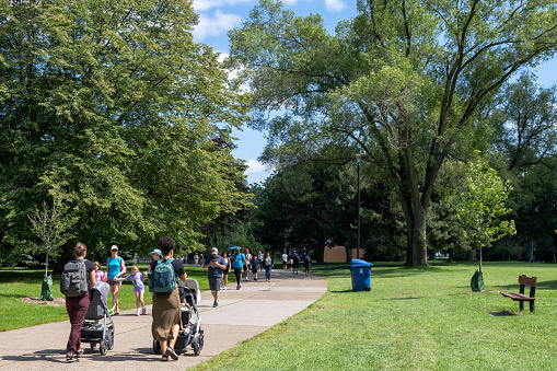 Toronto, Ontario, Canada - July 30 2021 : People walking in the Toronto Islands Centre Island Park.