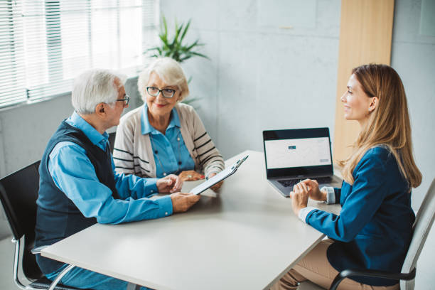 istock Senior couple consulting with female advisor 1424413944