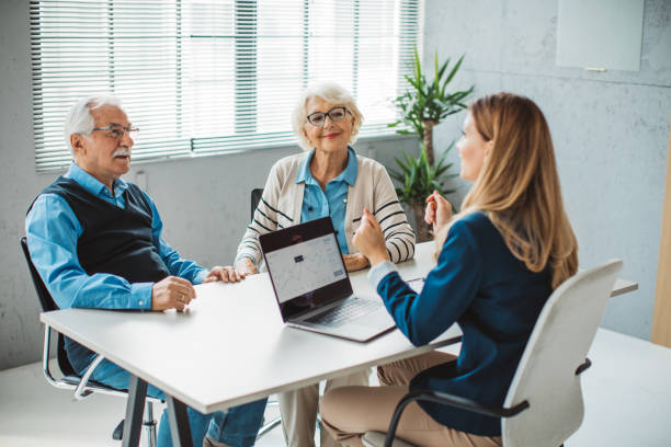 istock Senior couple consulting with female advisor 1424413945