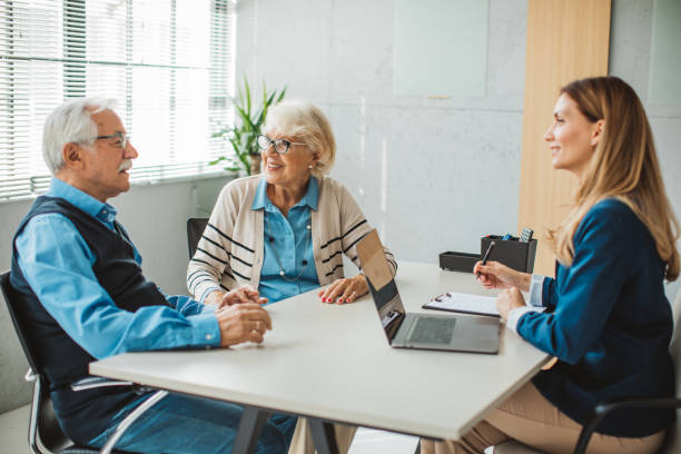istock Senior couple consulting with female advisor 1424413949