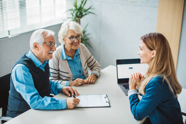 Senior couple consulting with female advisor
