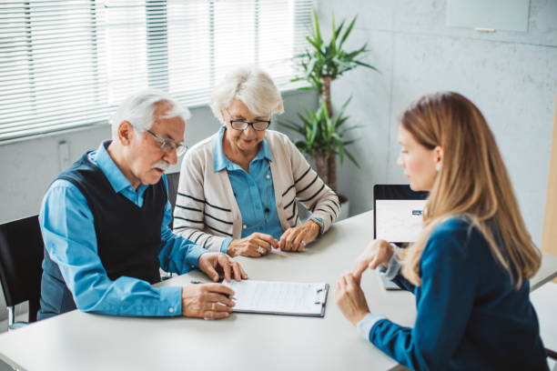 istock Senior couple consulting with female advisor 1424413970