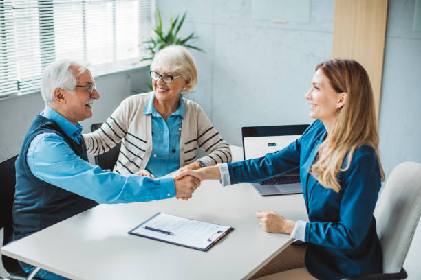 istock Senior couple consulting with female advisor 1424413978