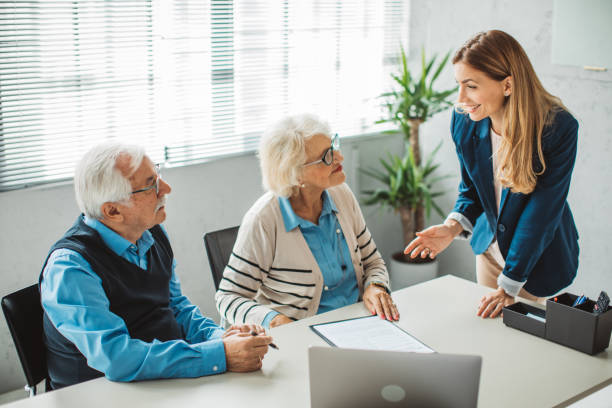 istock Senior couple consulting with female advisor 1424414041