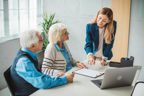 istock Senior couple consulting with female advisor 1424414048