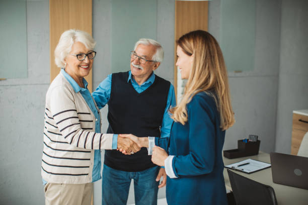istock Senior couple consulting with female advisor 1424414080