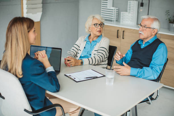 istock Senior couple consulting with female advisor 1424414093