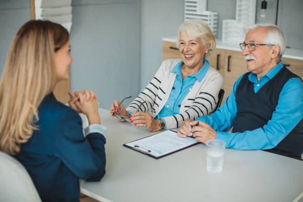 istock Senior couple consulting with female advisor 1424414105