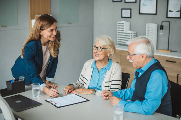 istock Senior couple consulting with female advisor 1424414112