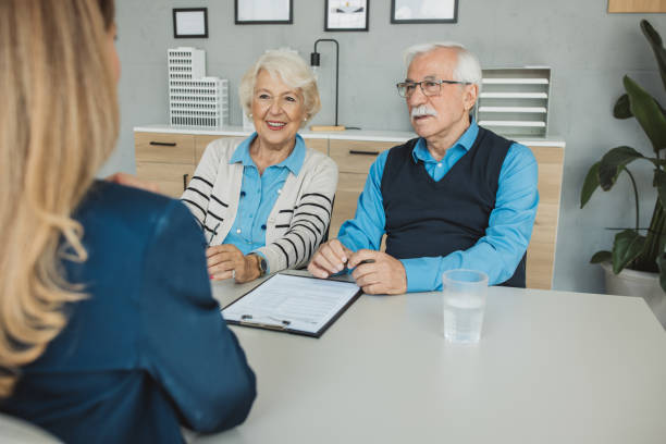 istock Senior couple consulting with female advisor 1424414186