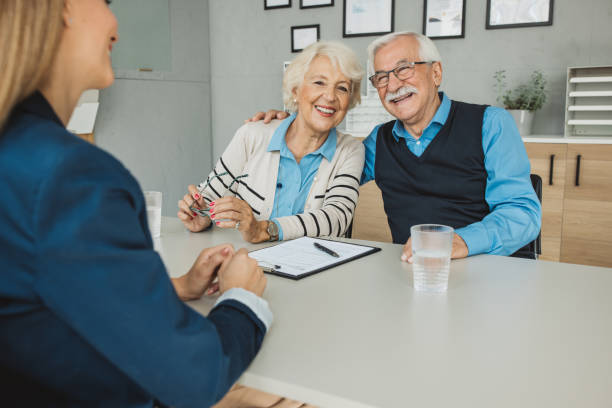 istock Senior couple consulting with female advisor 1424414236