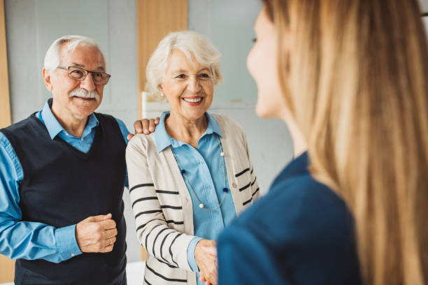 istock Senior couple consulting with female advisor 1424414282