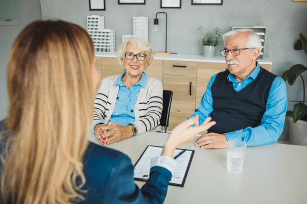 istock Senior couple consulting with female advisor 1424414318