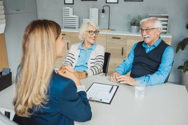 istock Senior couple consulting with female advisor 1424414320