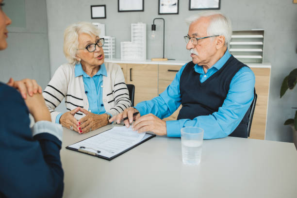 istock Senior couple consulting with female advisor 1424414339