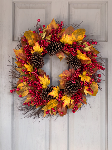 Autumn fall wreath hanging on front door