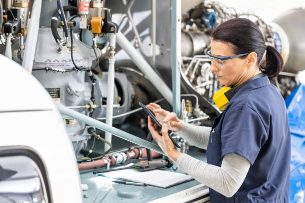 istock Female airplane mechanic examining private helicopter, side view 1424424639