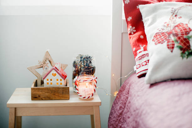 istock Christmas home decor. Candle, ceramic house, jar with cone 1424425743