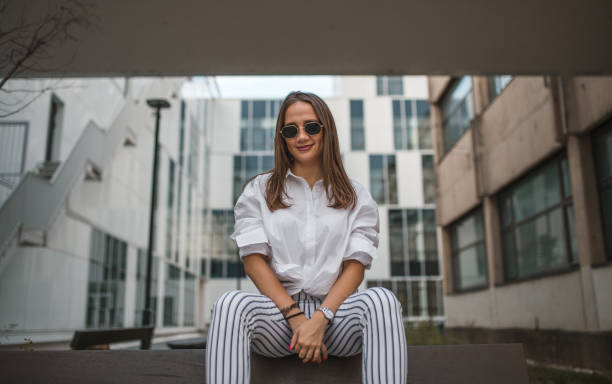 istock A smiling woman sits on the bench 1424436655