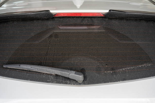 istock rear window hatchback dirty car rear view on a dusty glass. 1424439630