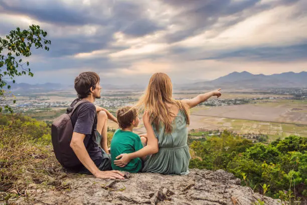 Photo of Happy tourists mom, dad and son travel to Vietnam. Travel to Asia concept. Traveling with kids concept