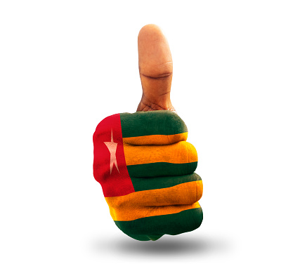 Thumbs up painted in Togolese flag colors isolated on white background. National flag of Togo